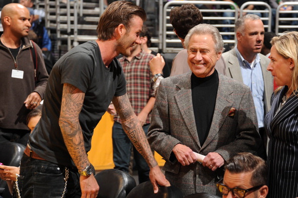 Soccer star David Beckham and entrepreneur Philip Anschutz talk before a game between the New Orleans Hornets and the Los Angeles Lakers