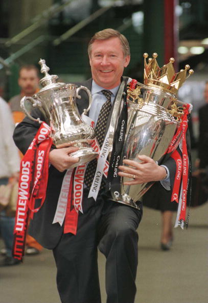 12th May 1996; Manchester United manager Alex Ferguson with the FA Cup and Premiership trophy on his arrival at Manchester's Victoria station