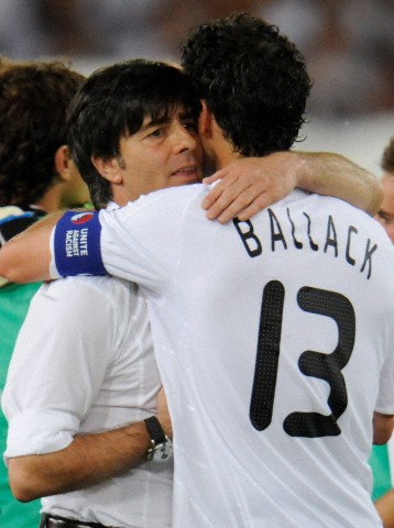 25 June 2008 of Michael Ballack (R) hugging Joachim Loew in Basel, Switzerland.