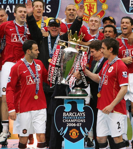 Manchester United Manager Sir Alex Ferguson celebrates as Ryan Giggs (L) and Gary Neville of Manchester United lift the Premiership trophy 2007