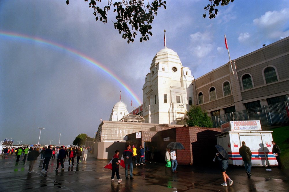 A rainbow emerges in the sky from behind the twin towers at the old Wembley stadium