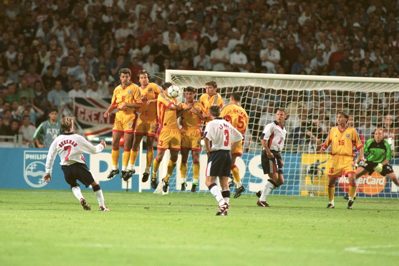 Becks curls a free kick over the Romania wall during the World Cup group match in 1998