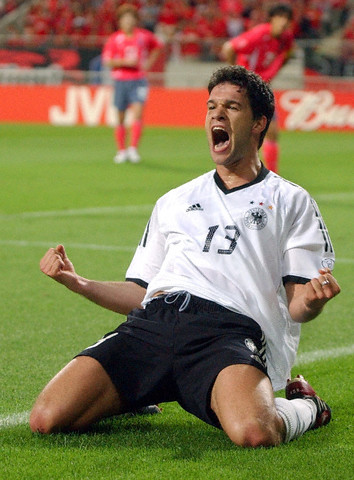 German midfielder Michael Ballack kneels on the pitch and lets out a jubilant scream after scoring the 1-0 lead during the 2002 World Cup semi-final Germany against South Korea in Seoul