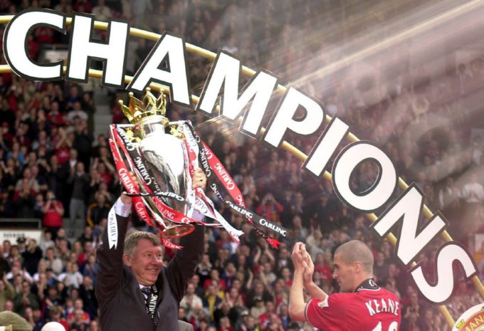 Ferguson and captain Roy Keane lift the Premier League trophy (his seventh league title in charge) after securing it against Derby County, May 2001