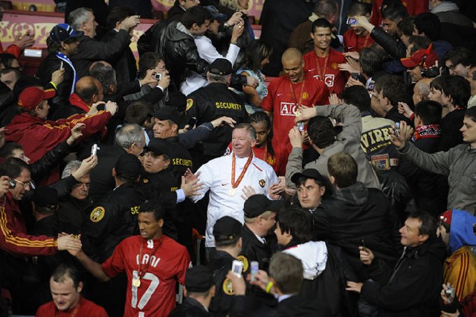 Ferguson pushes through the crowd on the way to lift the Champions League trophy at the Luzhniki Stadium in Moscow, May 2008