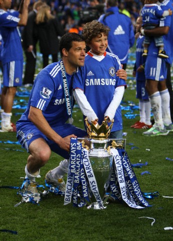 Michael Ballack of Chelsea and his son Jordi celebrate winning the Premier League with the trophy 2010